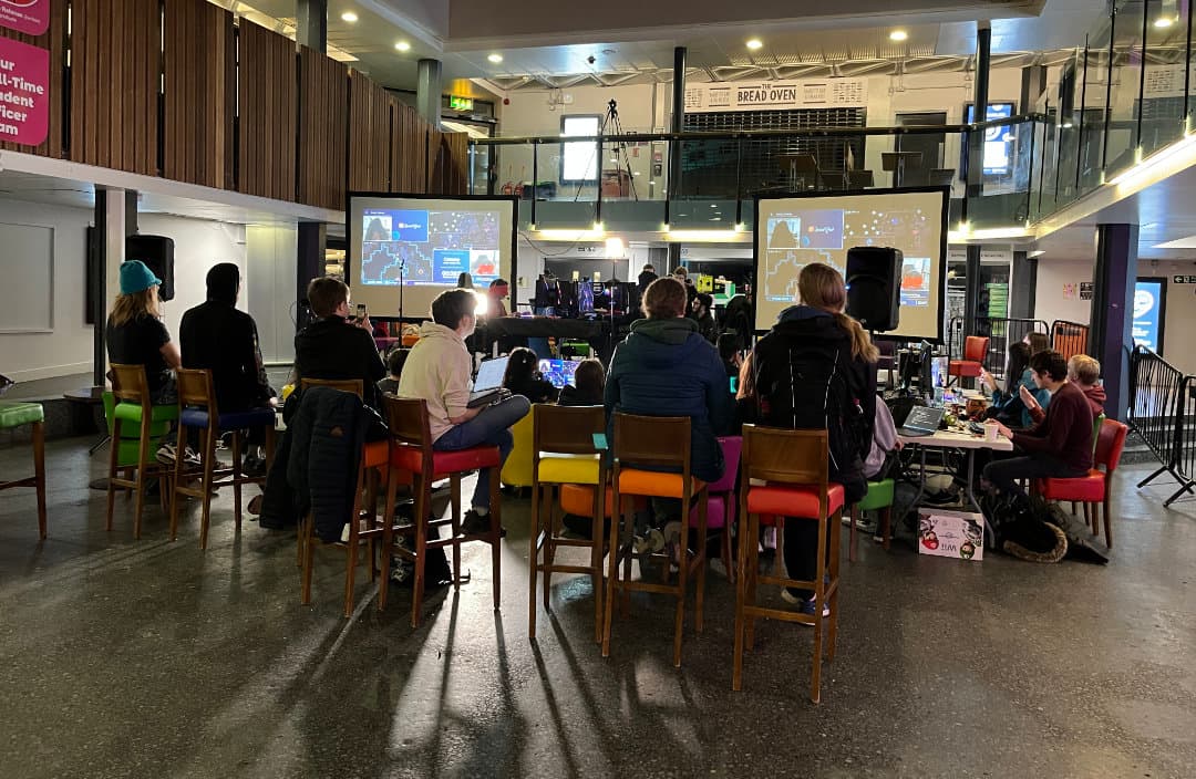 Audience watching WASD in the SU Atrium